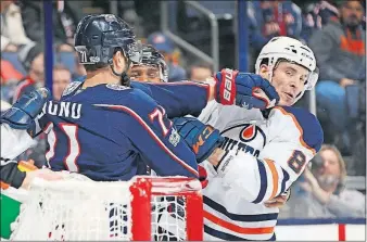  ?? [ADAM CAIRNS/DISPATCH] ?? The Jackets’ Nick Foligno, left, gets into a scrap with the Oilers’ Yohann Auvitu in the first period.