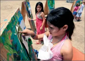  ?? Arkansas Democrat-gazette/staton BREIDENTHA­L ?? Sisters Isabelle, 7, (left) and Alisa Pantoja, 8, paint Sunday afternoon in the Family Zone area at Riverfest in Little Rock.