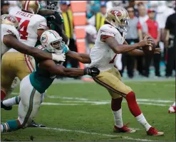 ?? AP PHOTOS ?? San Francisco 49ers quarterbac­k Colin Kaepernick (7) is sacked by Miami Dolphins defensive end Cameron Wake (91).