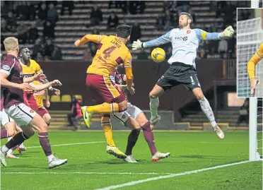 ?? ?? Rickie Lamie powers the ball past Craig Gordon to seal the win for the Steelmen