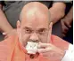  ??  ?? BJP president Amit Shah listens to Prime Minster Narendra Modi’s Mann Ki Baat over tea, in Ahmedabad, as part of the party’s campaign on Sunday. — PTI