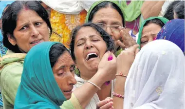  ??  ?? Distraught mothers wail during the funeral gathering.