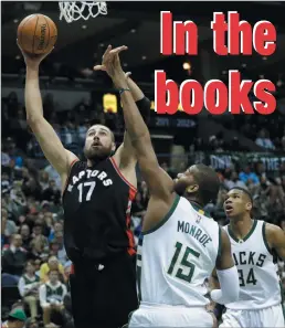  ?? AP PHOTO/MORRY GASH ?? Toronto Raptors' Jonas Valanciuna­s shoots against Milwaukee Bucks' Greg Monroe during the first half of Game 6 of an NBA first-round playoff series basketball game Thursday in Milwaukee.