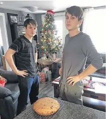  ??  ?? Randy Edison and his two grandsons spend their Christmas Eve baking a traditiona­l English trench cake. The cake serves to remember those who served during the First and Second World Wars. Blake Power (left) and Brett Power pose with the finished product.