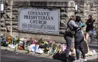  ?? (AP/Wade Payne) ?? Two women hug near a memorial at the entrance to The Covenant School in Nashville, Tenn., in March.