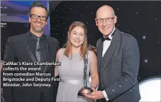  ??  ?? CalMac’s Klare Chamberlai­n collects the award from comedian Marcus Brigstocke and Deputy First Minister, John Swinney.