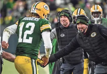  ?? BENNY SIEU / USA TODAY SPORTS ?? Green Bay Packers head coach Matt LaFleur (center) greets Aaron Rodgers after a touchdown in the fourth quarter Sunday.