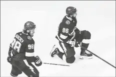  ?? ASSOCIATED PRESS ?? TAMPA BAY LIGHTNING’S MIKHAIL SERGACHEV (98) and Nikita Kucherov (86) celebrate a goal against the New York Islanders during the third period of Game 2 of the NHL Eastern Conference final on Wednesday in Edmonton, Alberta.