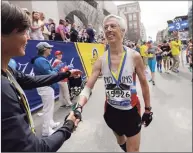  ?? Elise Amendola / Associated Press ?? Three-time Boston Marathon winner Uta Pipping, left, congratula­tes Ben Beach after he finished running his 50th consecutiv­e Boston Marathon in 2017.