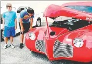  ?? FILE PHOTO ?? John Weaver, left and his brother Mason Weaver, of Prairie Grove, enjoy the third annual Chicken Rod Nationals car show in Lincoln last year. This year’s show will be held Saturday on Lincoln square.