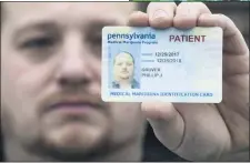  ?? ASSOCIATED PRESS ?? In this 2018photo, Phil Gruver poses for a photograph with his Pennsylvan­ia medical marijuana card in Emmaus, Pa.