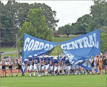  ?? Blake Silvers ?? The 2021 Gordon Central Warriors football team takes the field before their preseason scrimmage with the Colts of Coahulla Creek Friday night at Ratner Memorial Stadium.