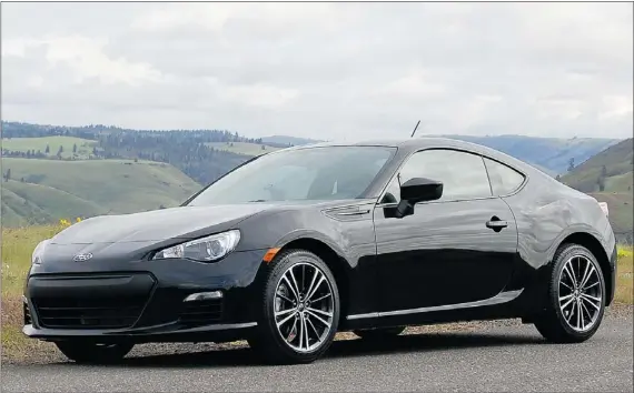  ?? — POSTMEDIA NEWS PHOTOS ?? The powerful boxer engine and the car’s responsive handling makes the 2013 Subaru BRZ a joy to drive.