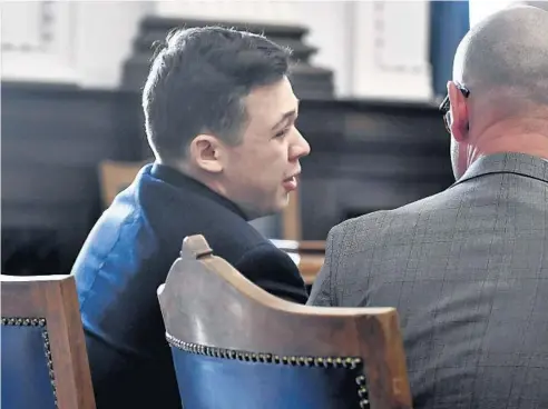  ?? SEAN KRAJACIC/THE KENOSHA NEWS ?? Kyle Rittenhous­e, left, cries after he was found not guilty on all counts at the Kenosha County Courthouse in Kenosha on Friday.