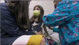  ?? SHAWN ROCCO — DUKE HEALTH ?? Alejandra Gerardo, 9, looks up to her mom, Dr. Susanna Naggie, as she gets the first of two Pfizer COVID-19 vaccinatio­ns during a clinical trial for children at Duke Health in Durham, N.C., on Wednesday.