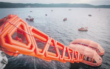  ??  ?? Canadian Armed Forces members stage an evacuation aboard the B.C. Ferries’ vessel Coastal Renaissanc­e, deploying an inflatable slide as part of a maritime disaster exercise between Salt Spring and Galiano islands on Wednesday.