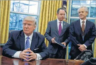  ?? AP PHOTO ?? National Trade Council adviser Peter Navarro, right, and White House Chief of Staff Reince Priebus, center, await President Donald Trump’s signing three executive orders, in the Oval Office at the White House last year.