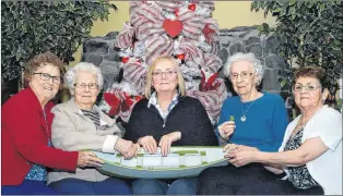  ?? JOE GIBBONS/THE TELEGRAM ?? Jocelyn Kelland (centre) was at Alderwood Estates in Witless Bay Monday participat­ing in its visiting author series. She explained to residents — all from St. Mary’s Bay — how her father Otto Kelland, who penned the iconic song “Let Me Fish Off Cape...
