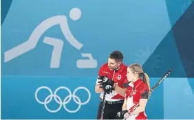  ?? STEVE RUSSELL TORONTO STAR FILE PHOTO ?? Canadians Kaitlyn Lawes and John Morris strategize before winning gold at the 2018 Pyeonchang Winter Olympics in South Korea.