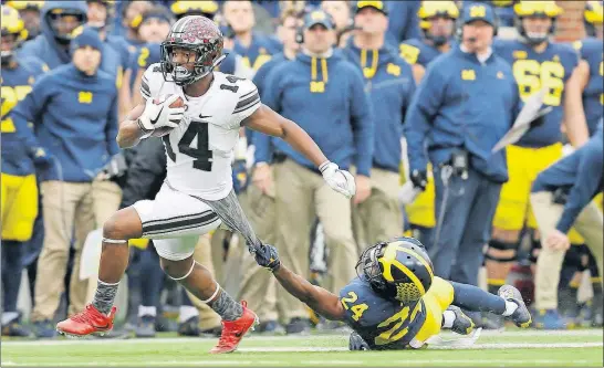  ?? [ADAM CAIRNS/DISPATCH] ?? Ohio State receiver K.J. Hill eludes Michigan defensive back Lavert Hill during the fourth quarter.