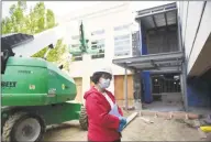  ??  ?? Greenwich Library Director Barbara Ormerod-Glynn stands at the new library entrance while touring the work site. The library has been closed during the coronaviru­s outbreak, so the library’s renovation has been able to move forward ahead of schedule. It is expected to be done before the end of the year.