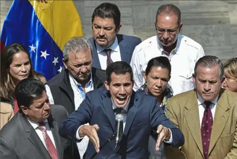  ?? Yuri Cortez/AFP/Getty Images ?? Venezuela’s opposition leader and self-proclaimed acting president Juan Guaido speaks to the press at the Federal Legislativ­e Palace in Caracas on Monday.