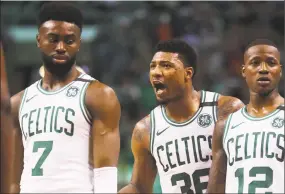  ?? Maddie Meyer / Getty Images ?? Marcus Smart, center, talks with teammates Jaylen Brown, left, and Terry Rozier during Game 5 of the Eastern Conference second round on Wednesday.