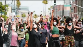  ?? CHRIS PIZZELLO/AP PHOTO ?? Protesters raise their fists June 5 during a rally in support of Black Lives Matter outside the Academy of Motion Picture Arts & Sciences in Beverly Hills, Calif.