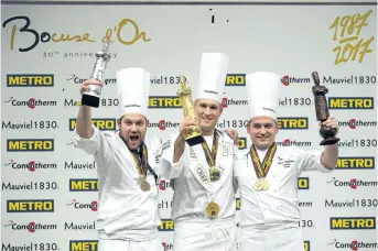  ?? LAURENT CIPRIANI/AP FILE PHOTO ?? Mathew Peters of the U.S., centre, in 2017 celebrates on the podium after winning the Bocuse d'Or (Golden Bocuse) trophy, in Lyon, central France, ahead Christophe­r William Davidsen of Norway, left, who finished second, and Viktor Andresson of Iceland,...