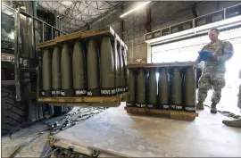  ?? ALEX BRANDON — THE ASSOCIATED PRESS ?? U.S. Air Force Staff Sgt. Cody Brown, with the 436th Aerial Port Squadron, checks pallets of 155 mm shells ultimately bound for Ukraine on Friday at Dover Air Force Base, Del.