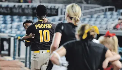  ?? MITCHELL LAYTON GETTY IMAGES ?? Jurickson Profar of the San Diego Padres runs off the field with family after shots were heard outside Nationals Park on Saturday.