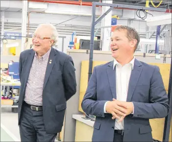  ?? COLIN MACLEAN/JOURNAL PIONEER ?? Premier Wade MacLauchla­n, left, and StandardAe­ro Summerside president Jeff Poirier are shown on a walk-through Monday of the company’s facility in Slemon Park.