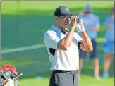  ?? USA TODAY SPORTS ?? Tiger Woods checks the yardage to the 10th green at the Southern Hills Country Club on Wednesday.