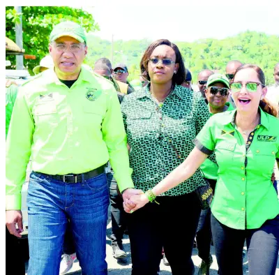  ?? PHOTOGRAPH­ER IAN ALLEN/ ?? From left: Jamaica Labour Party Leader Andrew Holness and his wife, Juliet, walk with the party’s candidate for the upcoming East Portland by-election, Ann-Marie Vaz, through the town of Port Antonio.