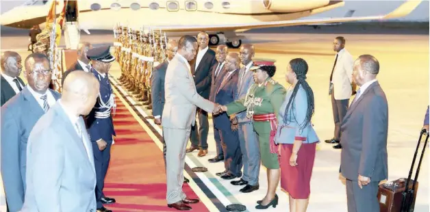  ?? Picture by EDDIE MWANALEZA/STATE HOUSE ?? President Edgar Lungu (left) greets Defence Attache at the Zambian High Commission Grace Zimba (right) on arrival at Maputo Internatio­nal Airport in Maputo,Mozambique. President Lungu is in Mozambique to witness the signing ceremony of a peace pact between the government and RENAMO. -