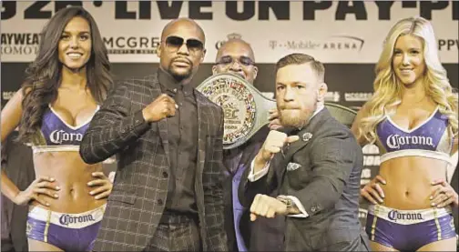  ?? AP ?? As anticipati­on mounts for highly hyped fight, Floyd Mayweather and Conor McGregor pose in final press conference Wednesday.