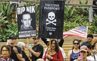  ?? DAMIAN DOVARGANES/ASSOCIATED PRESS ?? Protesters hold signs against vaccine passports as they participat­e in Saturday’s “S.O.S. California No Vaccine Passport Rally” in Santa Monica, California.