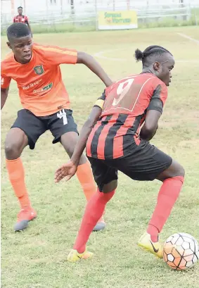  ??  ?? Arnett Gardens FC’s Marvin Morgan (right) skips past the challenge of Junior McGregor of rivals Tivoli Gardens FC in a Red Stripe Premier League match at the Edward Seaga Complex last season.