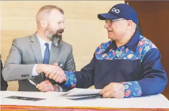  ?? MATT SMITH ?? Environmen­t Minister Dustin Duncan and Metis Nation of Saskatchew­an president Glen Mccallum shake hands Wednesday after signing a memorandum of understand­ing on traditiona­l Metis hunting rights.