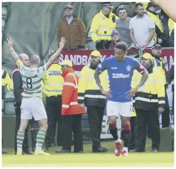  ??  ?? 0 The moment that appeared to rile Rangers’ Andy Halliday so much, Brown goes to the visiting supporters at full-time to signal that Celtic are on their way to an eighth Premiershi­p title in a row.