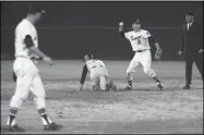  ?? MARION CROWE - THE ASSOCIATED PRESS ?? In this April 12, 1966, file photo, Atlants Braves second baseman Frank Bolling (2) throws the ball against the Pittsburgh Pirates during the first Major League Baseball game in the southeast at Atlanta-Fulton County Stadium.