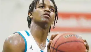  ?? STEPHEN M. DOWELL/ORLANDO SENTINEL ?? Olympia senior guard E.J.“Jizzle”James scored 29 points as the Titans rolled to victory against Wekiva in the Metro Conference West Division boys basketball championsh­ip game Friday.