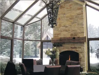  ?? PHOTO COURTESY OF ARCON SOLARIUM ?? A glass-enclosed solarium with a stone fireplace makes for a wonderful place to enjoy the outdoors, even when it’s cold and snowy outside.