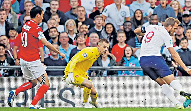  ??  ?? Starting point: Harry Kane shoots and puts England on course for a comfortabl­e win
