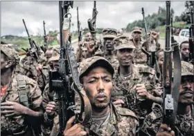  ?? Photos: Solan Kolli/getty Images & Amanuel Sileshi/getty Images ?? Hunters, hunted: Fano militia (left) in Lalibela, Ethiopia, in 2021 during the civil war in which they fought alongside soldiers from the Ethiopian National Defence Force (right) now said to be hunting them.