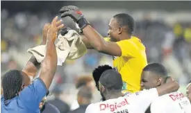  ?? IAN ALLEN ?? Cavalier goalkeeper Vino Barclett (top) celebrates with his teammates after making the winning penalty shootout save in their Jamaica Premier League second leg quarter-final game against Mount Pleasant at Sabina Park in Kingston yesterday.