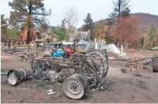  ?? AP PHOTO/FELICIA FONSECA ?? An all-terrain vehicle that was burned by a massive wildfire outside Flagstaff, Ariz., sits outside the home of Jeanne and Mike Welnick, on Tuesday.