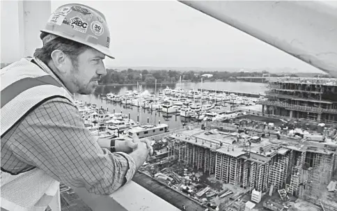  ??  ?? Paleologos, a vice president at Long & Miller, looks over the Wharf waterfront constructi­on project in Southwest Washington. — WP-Bloomberg photo