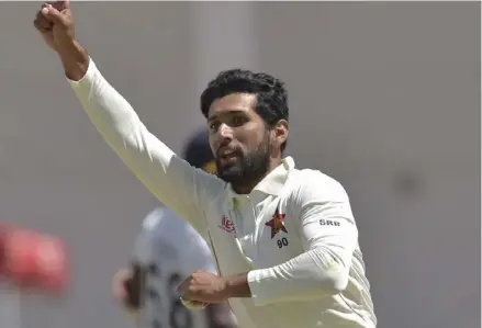  ??  ?? Sikandar Raza celebrates after taking a wicket