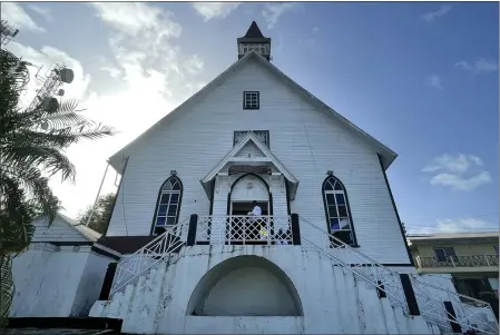  ?? PHOTOS BY LUIS ANDRES HENAO — THE ASSOCIATED PRESS ?? A man stands at the entrance of First Baptist Church on Colombia’s San Andres Island on Aug. 21. The church is a symbol of emancipati­on and a source of pride for the Raizals, the English-speaking, mostly Protestant inhabitant­s of San Andres and smaller islands that form an archipelag­o in the western Caribbean.